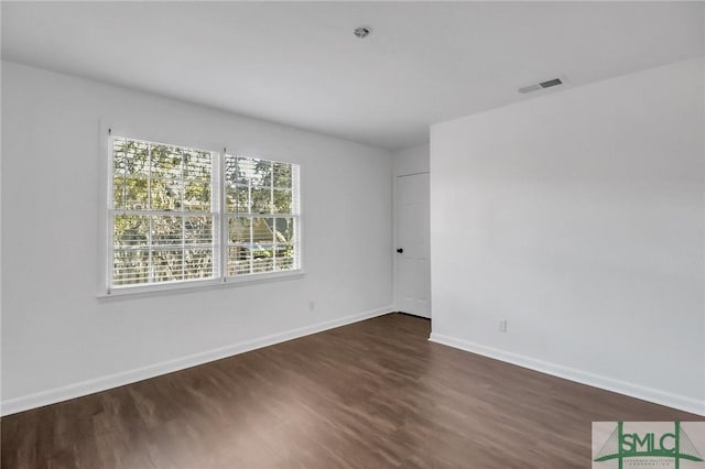 empty room featuring dark hardwood / wood-style floors