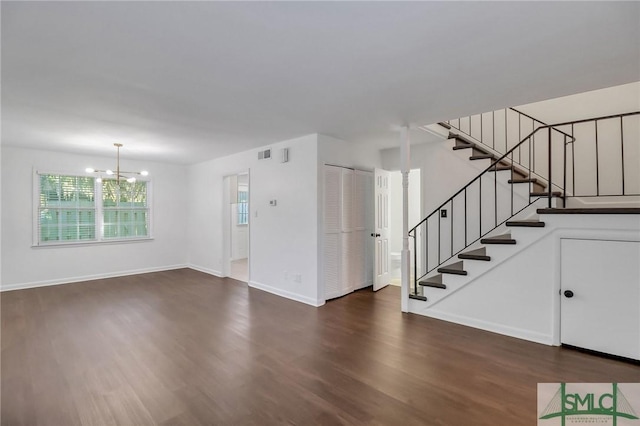 interior space with dark wood-type flooring and a notable chandelier