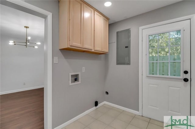 laundry room featuring a notable chandelier, electric panel, cabinets, and hookup for a washing machine