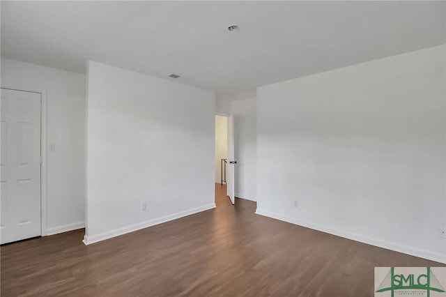 unfurnished room featuring dark hardwood / wood-style flooring