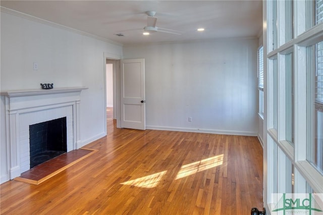 unfurnished living room with ceiling fan, hardwood / wood-style floors, and crown molding