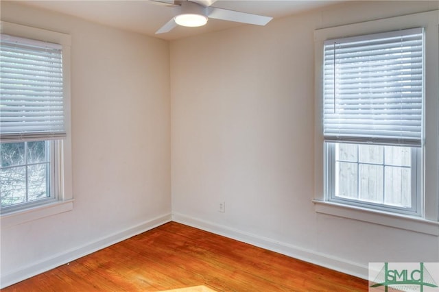 empty room featuring ceiling fan, a healthy amount of sunlight, and light wood-type flooring