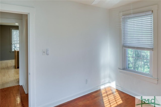 spare room with dark hardwood / wood-style flooring