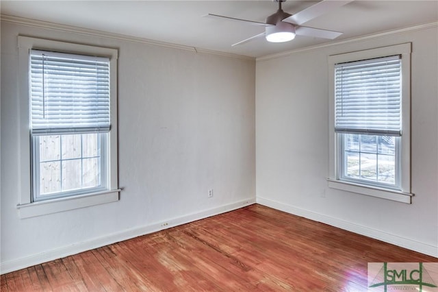 empty room featuring hardwood / wood-style flooring, ceiling fan, and crown molding