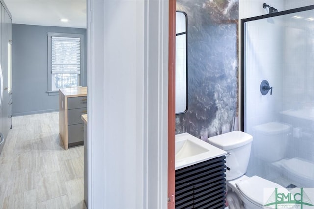 bathroom featuring vanity, an enclosed shower, and toilet