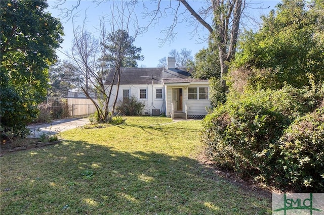 exterior space featuring a lawn and central AC