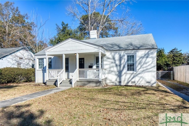 view of front of home with a front yard and a porch