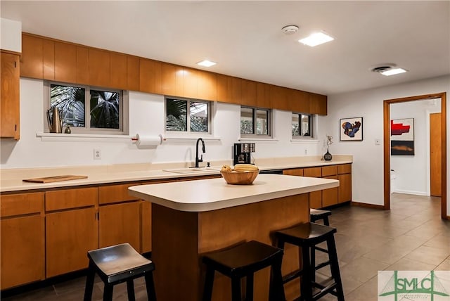 kitchen featuring a kitchen breakfast bar and sink