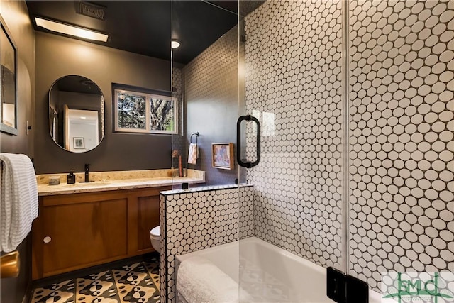 bathroom featuring tile patterned floors, vanity, and toilet