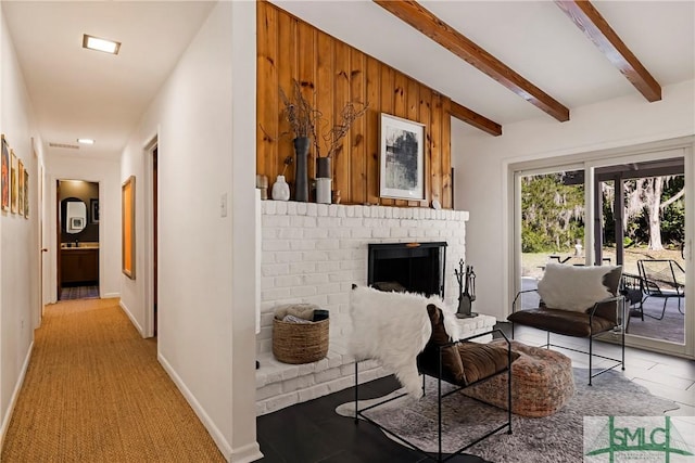 living room featuring beamed ceiling