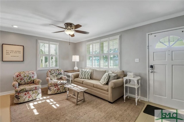 living room with ceiling fan and crown molding