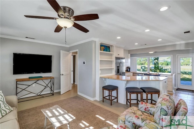 living room featuring crown molding and ceiling fan