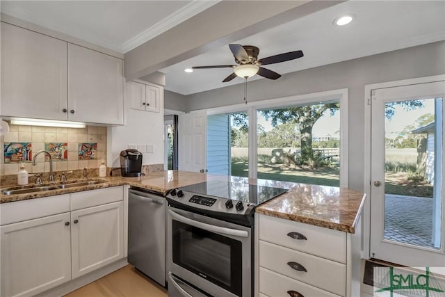 kitchen with white cabinetry, dark stone counters, and appliances with stainless steel finishes