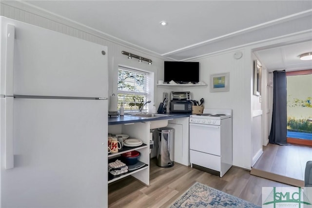 kitchen with white refrigerator, range, sink, and light hardwood / wood-style flooring