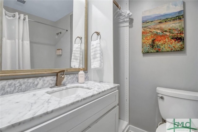 bathroom featuring vanity and toilet