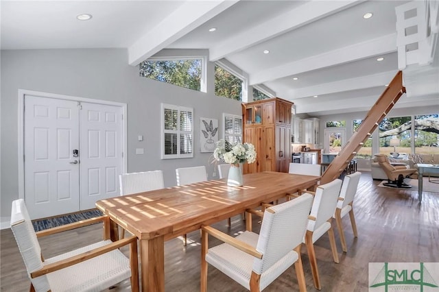 dining area with lofted ceiling with beams, dark wood-type flooring, and a healthy amount of sunlight