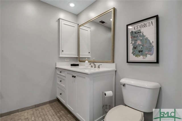 bathroom with tile patterned flooring, vanity, and toilet