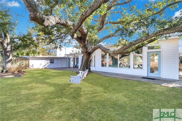 rear view of property with a yard