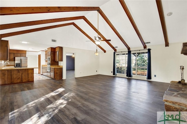 unfurnished living room featuring high vaulted ceiling, ceiling fan, dark wood-type flooring, and sink