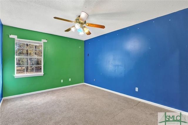 carpeted empty room featuring ceiling fan and a textured ceiling