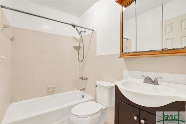 full bathroom with backsplash, toilet, vanity, tile walls, and tiled shower / bath