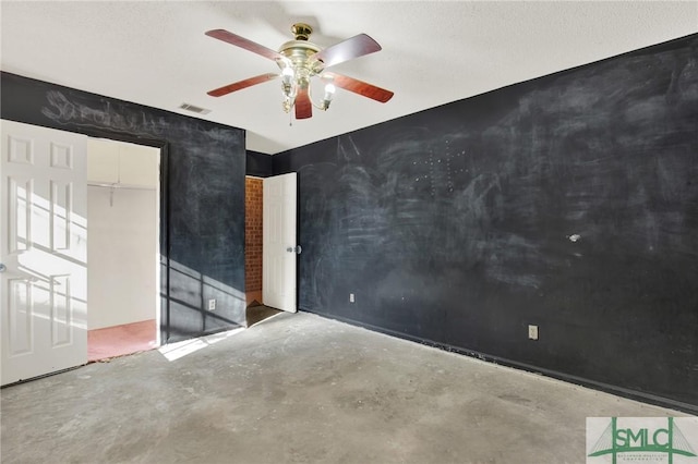 spare room featuring concrete floors and ceiling fan