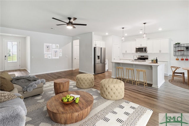 living room featuring light hardwood / wood-style floors and ceiling fan