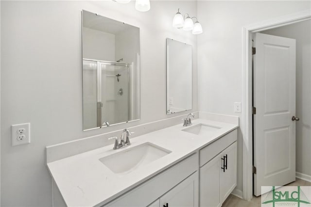 bathroom with vanity and a shower with door