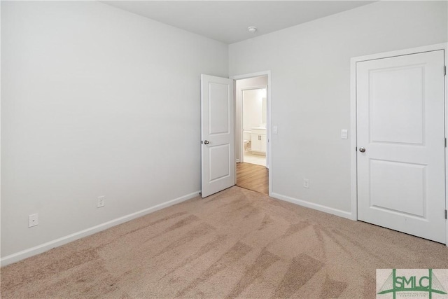 unfurnished bedroom featuring light colored carpet