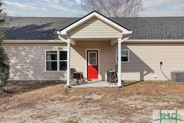 rear view of house featuring central AC and a patio area