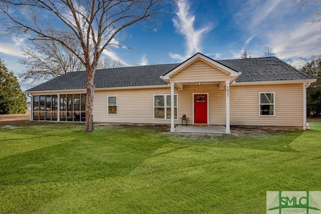 back of house with a sunroom, a patio area, and a lawn