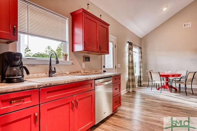 kitchen with sink, light wood-type flooring, dishwasher, and vaulted ceiling