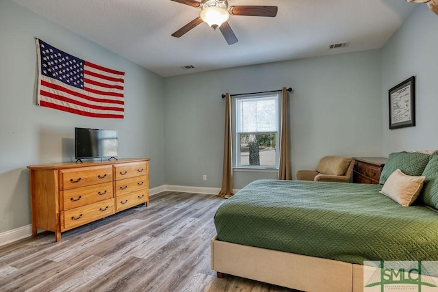 bedroom with ceiling fan and wood-type flooring