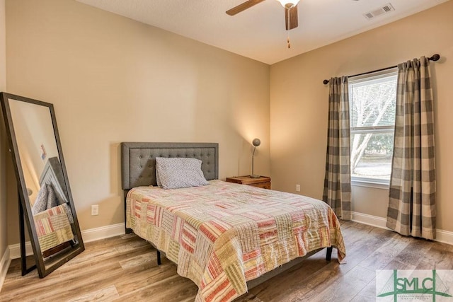 bedroom with ceiling fan and hardwood / wood-style flooring