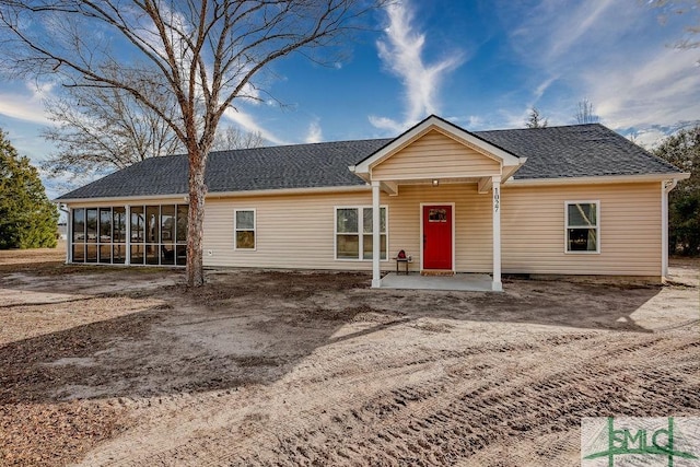 single story home featuring a patio and a sunroom