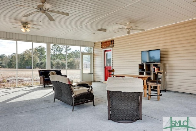 sunroom / solarium with a healthy amount of sunlight and ceiling fan