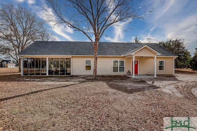 view of front of home with a patio area and a sunroom