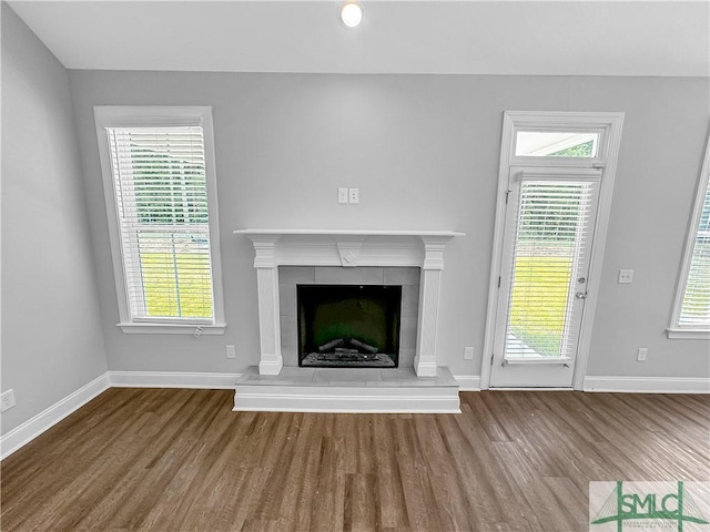 unfurnished living room featuring a fireplace and hardwood / wood-style floors