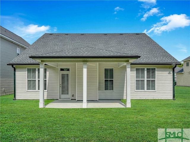 back of house featuring a patio area and a lawn