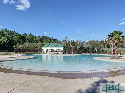 community pool with a patio area