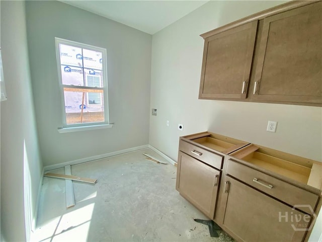 washroom with hookup for an electric dryer and baseboards