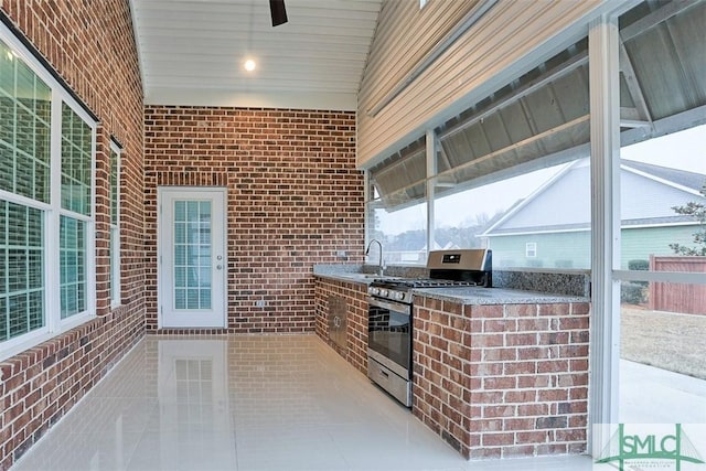 view of patio featuring area for grilling and sink