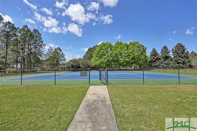 view of sport court featuring a lawn