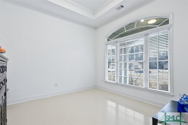 interior space with tile patterned floors, a raised ceiling, and crown molding