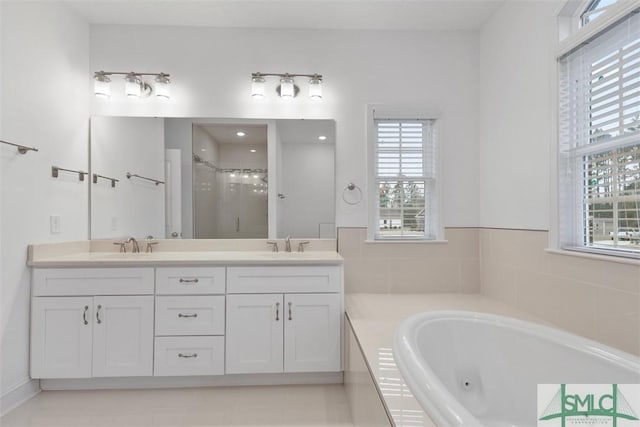 bathroom with tile patterned floors, vanity, and independent shower and bath