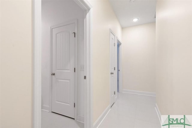 hall featuring light tile patterned floors