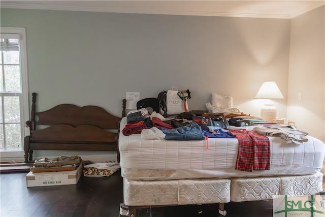 bedroom with crown molding and hardwood / wood-style floors