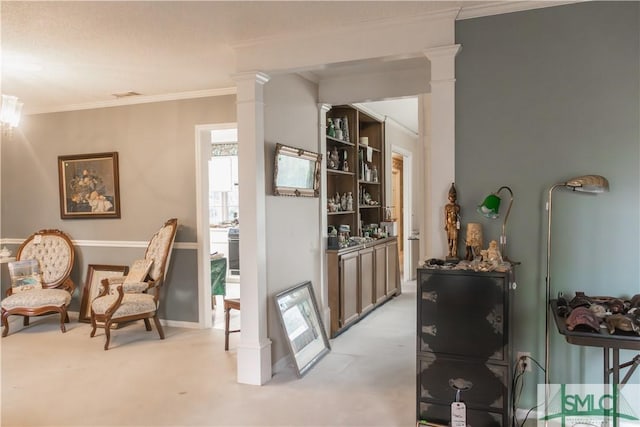 living area featuring decorative columns, light carpet, and crown molding