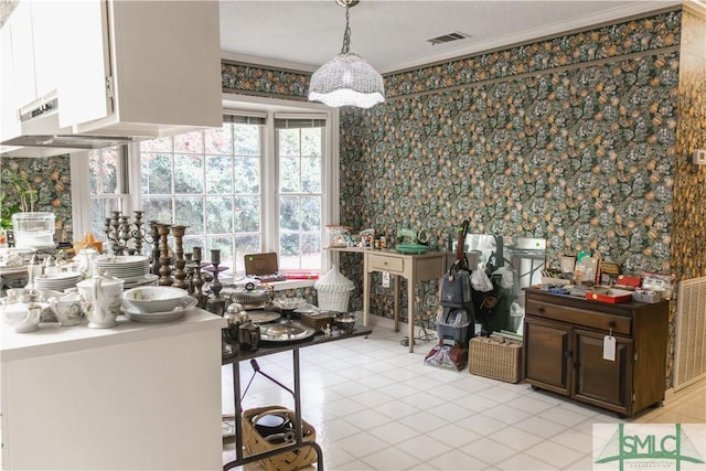 interior space featuring light tile patterned floors and ornamental molding