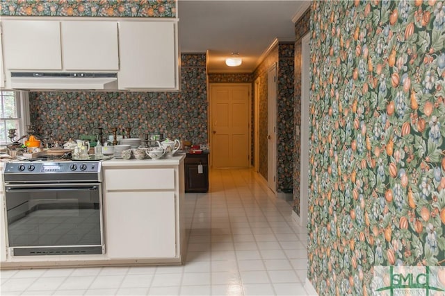 kitchen featuring white cabinetry, electric range, crown molding, and exhaust hood